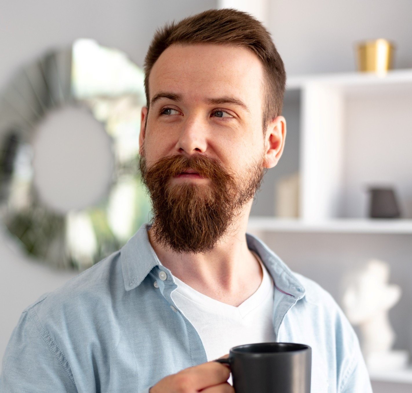 Testimonials young bearded man smiling and drinking coff.jpg